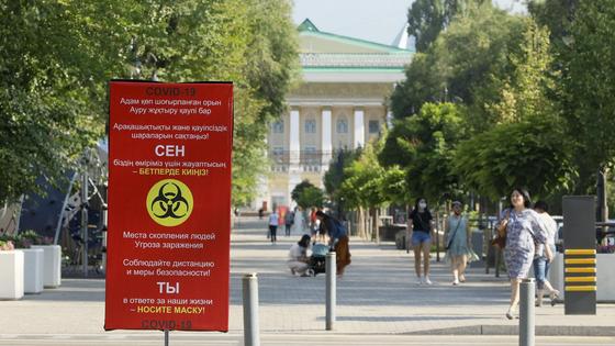 Люди в масках идут по улице Люди в масках идут по улице