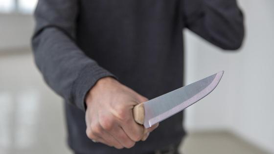 Мужчина держит нож Мужчина держит нож