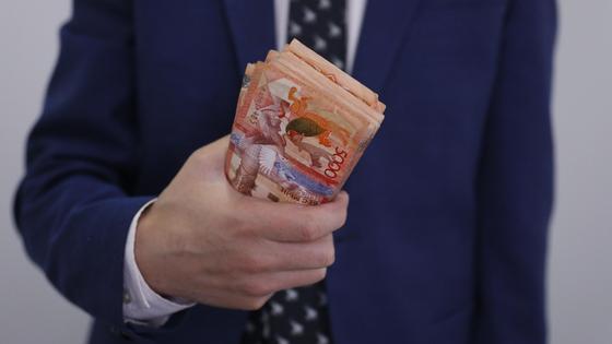 мужчина держит пачку денег в руках мужчина держит пачку денег в руках