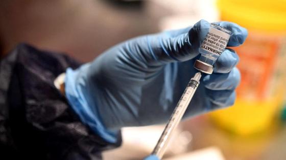 Медработник набирает в шприц вещество из ампулы Медработник набирает в шприц вещество из ампулы