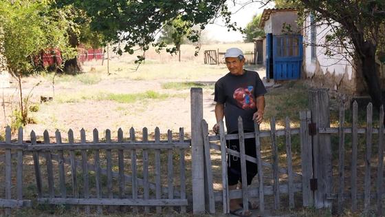 Мужчина стоит у забора Мужчина стоит у забора