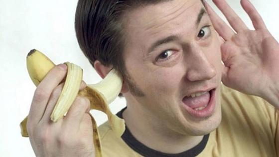 мужчина держит банан в ухе мужчина держит банан в ухе